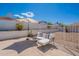 Inviting backyard seating area with comfortable cushions and an umbrella offering shade from the sun at 1811 E Tierra Buena Ln, Phoenix, AZ 85022