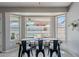 Bright dining area with views of the backyard pool through large windows at 1811 E Tierra Buena Ln, Phoenix, AZ 85022