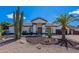 Charming home featuring desert landscaping, including saguaro cactus and a palm tree in the front yard at 1811 E Tierra Buena Ln, Phoenix, AZ 85022