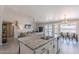 Open-concept kitchen island with granite counters, stainless steel appliances, and views of the living area and dining space at 1811 E Tierra Buena Ln, Phoenix, AZ 85022