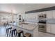 Stylish kitchen with white cabinets, granite countertops, and an island with barstool seating at 1811 E Tierra Buena Ln, Phoenix, AZ 85022