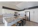 Modern kitchen featuring granite countertops, stainless steel appliances, and a breakfast bar with seating at 1811 E Tierra Buena Ln, Phoenix, AZ 85022