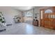 Bright living room featuring tile floors, a front door, and a large window with natural light at 1811 E Tierra Buena Ln, Phoenix, AZ 85022
