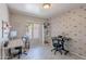 Well-lit office space with two desks, shelving, and stylish decor; perfect for remote work at 1811 E Tierra Buena Ln, Phoenix, AZ 85022