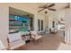 Cozy covered patio with comfortable seating and view of the sparkling pool at 1811 E Tierra Buena Ln, Phoenix, AZ 85022