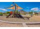 Community playground with a shaded play structure, swings, and exercise equipment at 1811 E Tierra Buena Ln, Phoenix, AZ 85022