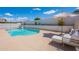 A refreshing pool is accompanied by an umbrella and a comfortable chaise lounge, perfect for relaxation at 1811 E Tierra Buena Ln, Phoenix, AZ 85022