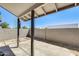 View of the home's back patio area, featuring a concrete surface and block wall surround for added privacy and seclusion at 1915 S 39Th St # 37, Mesa, AZ 85206