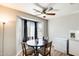 Bright dining area with hardwood floors, a ceiling fan, white walls, and a window with light-filtering shades at 1915 S 39Th St # 37, Mesa, AZ 85206