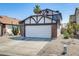 Charming home featuring a two-car garage, red brick accents, desert landscaping, and a palm tree at 1915 S 39Th St # 37, Mesa, AZ 85206