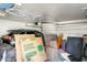 Cluttered garage containing a parked car and storage items at 1915 S 39Th St # 37, Mesa, AZ 85206
