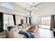 Bright living room with high ceilings, fan, lots of natural light, a large sectional, and sliding glass doors at 1915 S 39Th St # 37, Mesa, AZ 85206