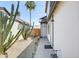 Home with a side yard featuring gravel, desert landscaping, flowers, a partial view of the backyard, and a gate at 1915 S 39Th St # 37, Mesa, AZ 85206