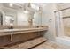 Well-lit bathroom with double sinks, elegant countertops, and a convenient shower and tub combination at 1946 E Caroline Ln, Tempe, AZ 85284