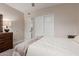 Bedroom with carpeted floor, ceiling fan, and a large closet with sliding doors at 1946 E Caroline Ln, Tempe, AZ 85284