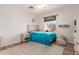 Bedroom with a large, framed window, providing plenty of natural light to the hardwood floors at 1946 E Caroline Ln, Tempe, AZ 85284