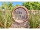 Stone sign for Alta Mira community, nestled among lush greenery and desert grasses under a bright blue sky at 1946 E Caroline Ln, Tempe, AZ 85284