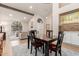 Inviting dining area with elegant decor, featuring a dark wood table and a view of the living room at 1946 E Caroline Ln, Tempe, AZ 85284