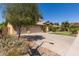 Spacious two-story home with a large driveway and a three-car garage with mature trees and landscaping at 1946 E Caroline Ln, Tempe, AZ 85284
