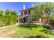 Charming home with a well-manicured lawn, mature trees, and a welcoming facade on a sunny day at 1946 E Caroline Ln, Tempe, AZ 85284
