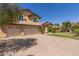Stunning home exterior featuring lush landscaping, a spacious driveway, and a convenient three-car garage at 1946 E Caroline Ln, Tempe, AZ 85284