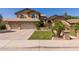 Charming two-story home featuring a lush lawn, mature palm trees, and a three-car garage, perfect for Gathering living at 1946 E Caroline Ln, Tempe, AZ 85284