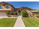 Inviting home featuring well-maintained lawn, desert landscaping, and charming architecture at 1946 E Caroline Ln, Tempe, AZ 85284