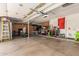 A well-lit garage with built-in storage cabinets and space for vehicles and hobbies at 1946 E Caroline Ln, Tempe, AZ 85284