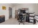 Functional home office with carpeted floor and organized bookshelf for a comfortable working environment at 1946 E Caroline Ln, Tempe, AZ 85284
