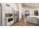 Kitchen showcases stainless steel appliances, built-in microwave, tiled backsplash and view to the living room at 1946 E Caroline Ln, Tempe, AZ 85284