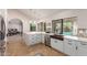 Bright kitchen features white cabinetry, stainless appliances, and a view of the backyard pool at 1946 E Caroline Ln, Tempe, AZ 85284