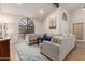 Inviting living room featuring plush sofas, a cozy rug, and a large window offering natural light at 1946 E Caroline Ln, Tempe, AZ 85284
