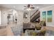 Open-concept living room with staircase and view to the kitchen at 1946 E Caroline Ln, Tempe, AZ 85284
