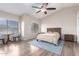 Spacious main bedroom with vaulted ceiling, ceiling fan, wood-look floors, and plenty of natural light at 1946 E Caroline Ln, Tempe, AZ 85284