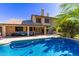 Backyard pool surrounded by lush landscaping and a covered patio seating area, perfect for relaxation and fun at 1946 E Caroline Ln, Tempe, AZ 85284
