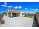 Well-maintained backyard with pavers, artificial grass, and a covered patio area at 20251 W Hadley St, Buckeye, AZ 85326