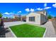 Expansive backyard featuring artificial grass, pavers, and desert landscaping at 20251 W Hadley St, Buckeye, AZ 85326