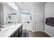 Contemporary bathroom featuring double sinks, a walk-in shower, and modern fixtures at 20251 W Hadley St, Buckeye, AZ 85326
