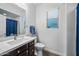 Bathroom with a single sink vanity with a white countertop and storage cabinets at 20251 W Hadley St, Buckeye, AZ 85326