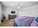 Bright bedroom with carpet, a large window, and a TV mounted on the wall at 20251 W Hadley St, Buckeye, AZ 85326