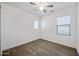 Bright bedroom with wood-look tile flooring, offering ample natural light from two windows at 20251 W Hadley St, Buckeye, AZ 85326