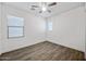 A bright and airy bedroom with wood-look flooring and large windows providing ample natural light at 20251 W Hadley St, Buckeye, AZ 85326