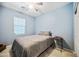 Comfortable bedroom with a ceiling fan, neutral carpet, and an inviting blue paint on the walls at 20251 W Hadley St, Buckeye, AZ 85326