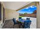 Comfortable covered patio featuring outdoor seating and a view of the green space at 20251 W Hadley St, Buckeye, AZ 85326