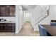 Bright entryway features wood look floors, a staircase with white railings, and a view into the home at 20251 W Hadley St, Buckeye, AZ 85326