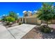 Charming stucco home with a two-car garage and manicured landscaping, perfect for curb appeal at 20251 W Hadley St, Buckeye, AZ 85326