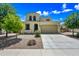 Lovely two-story home featuring a well-maintained front yard and two-car garage at 20251 W Hadley St, Buckeye, AZ 85326