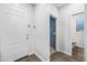 Inviting home foyer with a white front door and a view into a powder room at 20251 W Hadley St, Buckeye, AZ 85326