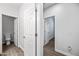 Hallway with wood-look tile, showcasing white trim, doors, and easy access to other rooms at 20251 W Hadley St, Buckeye, AZ 85326