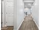 Hallway view features modern flooring and neutral tones, leading to open living spaces at 20251 W Hadley St, Buckeye, AZ 85326